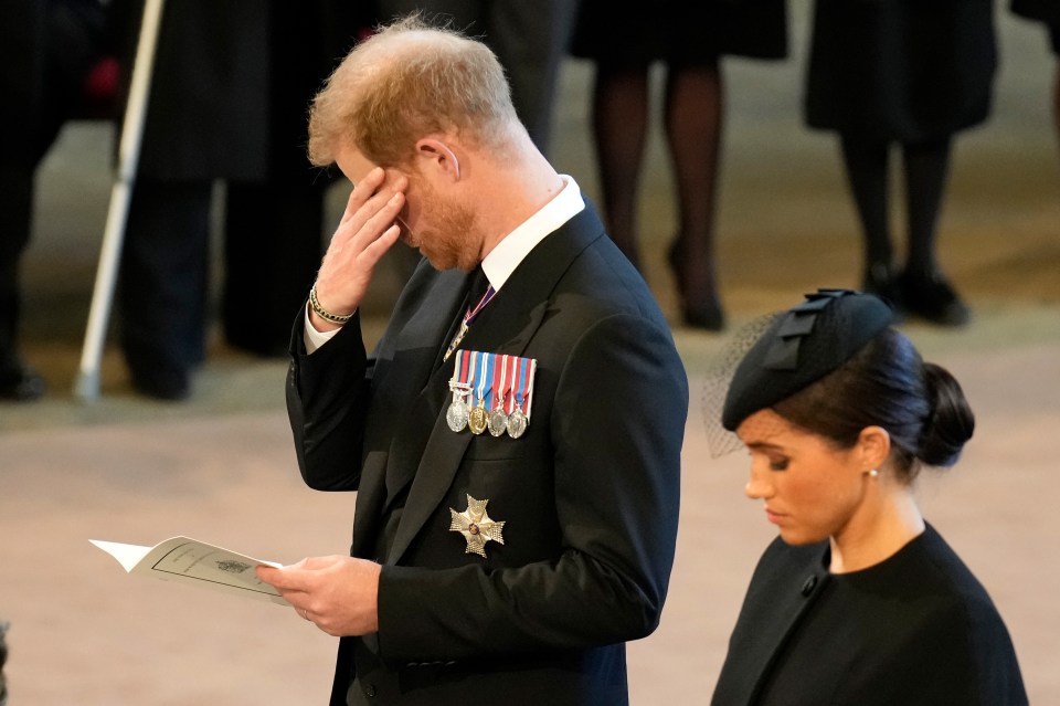 An emotional Prince Harry, Duke of Sussex and Meghan, Duchess of Sussex pay their respects in The Palace of Westminster