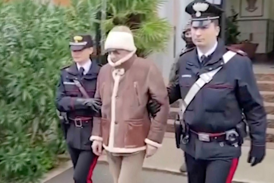 Denaro being escorted from a Carabinieri police station shortly after his arrest