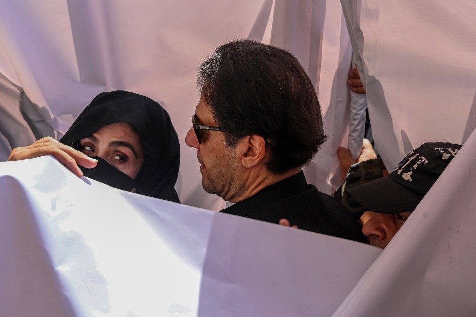 Khan and his wife arriving to appear at a high court in Lahore on May 15, 2023