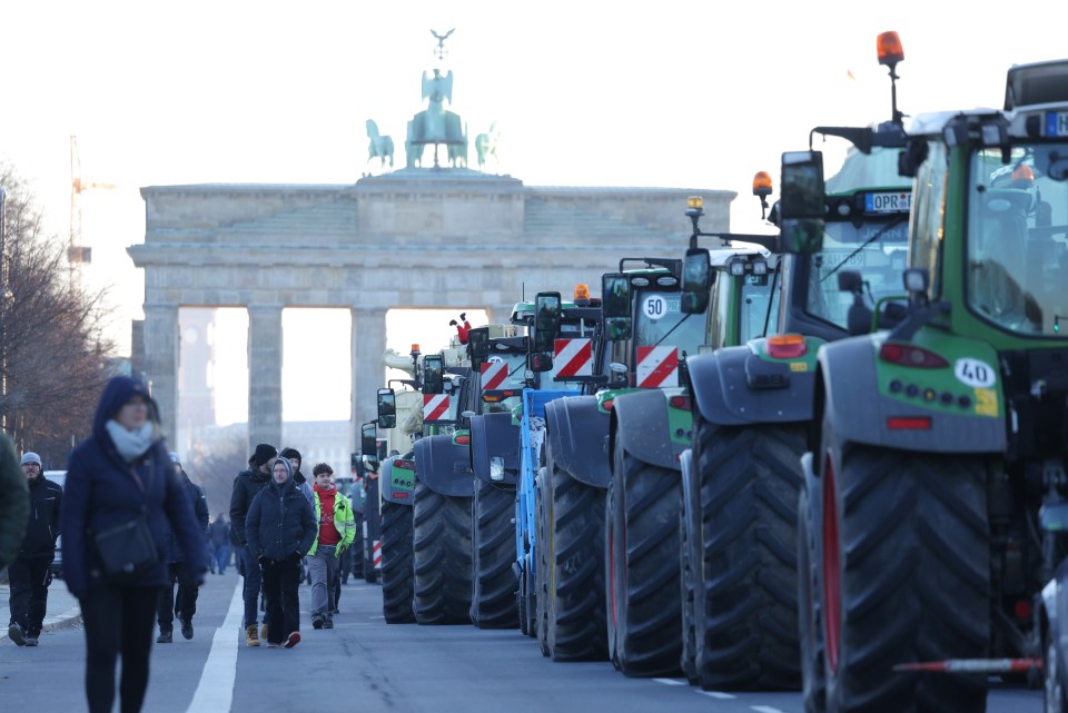 Tractors of protesting farmers line the streets in front of the Brandenburg Gate in Berlin