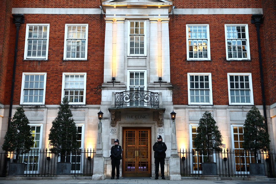 Two officers stand outside the London Clinic as Kate recovers