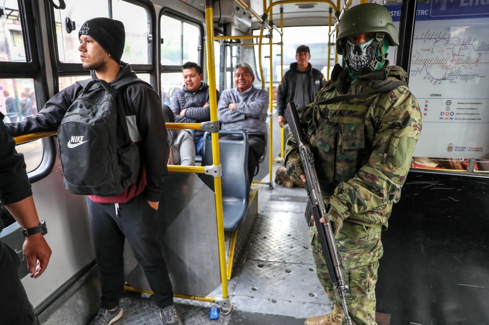 An Ecuadorian soldier participates in a control operation inside a public service bus at La Marin central public station in Quito