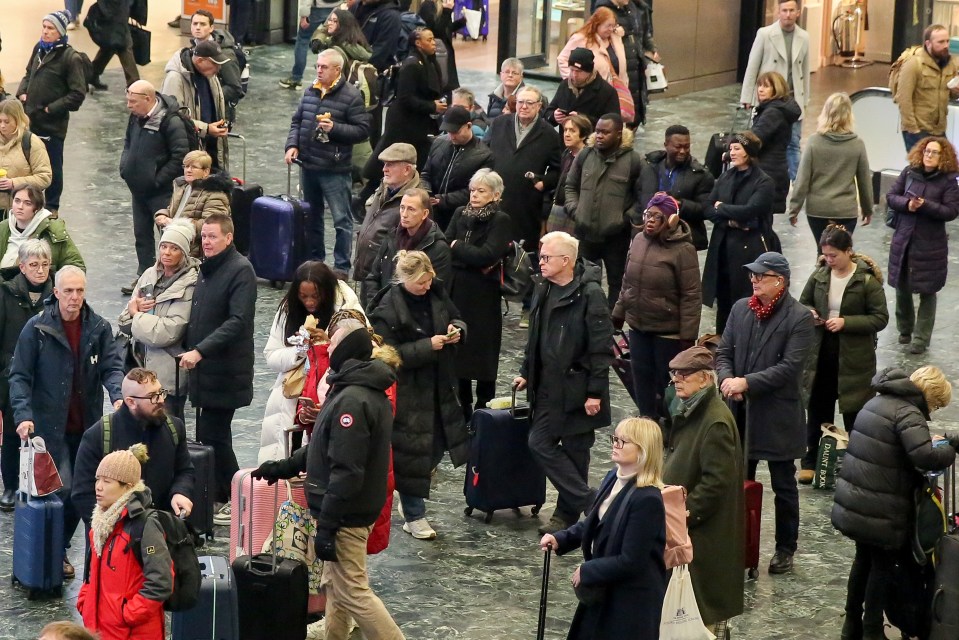 Stranded passengers wait for trains at Euston station in London