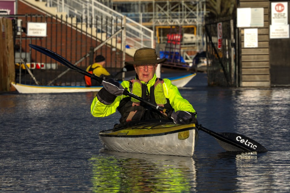 Robin Powell, 89, of the Worcester Canoe Club went kayaking on a flooded Worcester Racecourse this morning