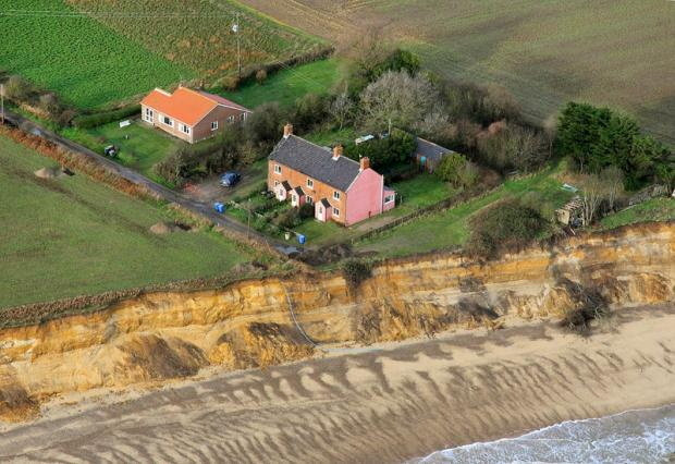 Anne Jones tore down three of her cliffside homes to stop them slipping into the sea