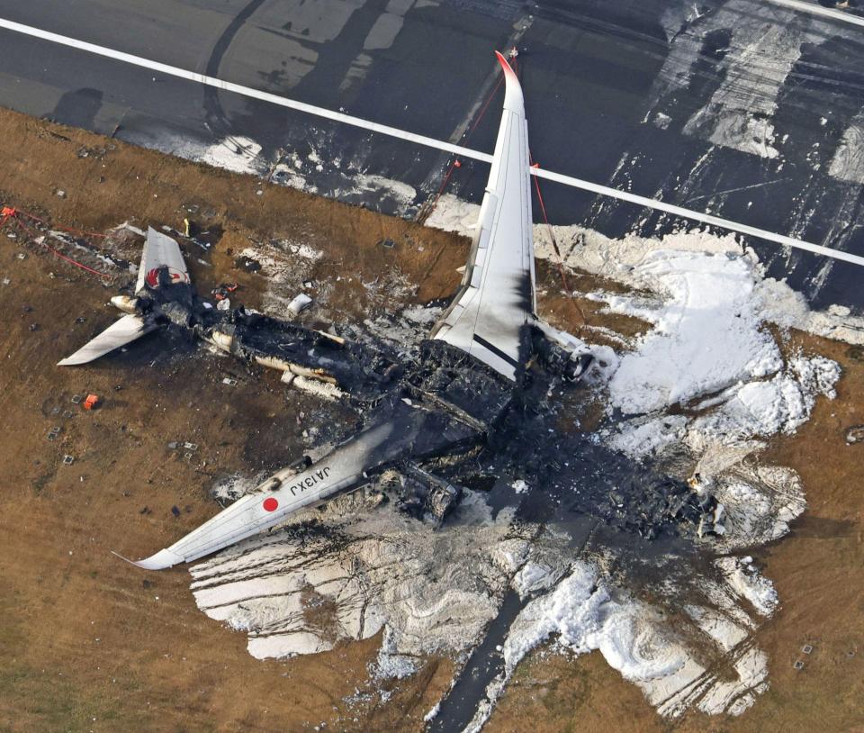 The charred wreckage of the Japan Airlines plane