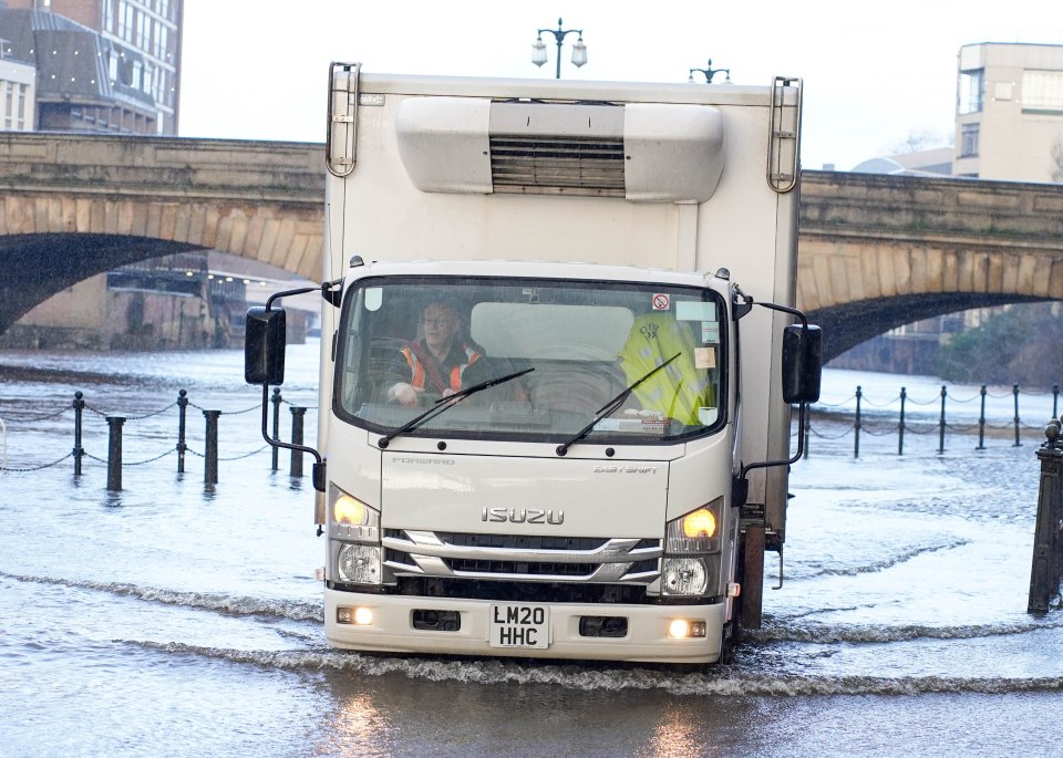 A lorry driver struggles to get through a flooded road after the River Ouse burst its banks in York