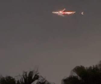 Red sparks flew through the air behind the aircraft