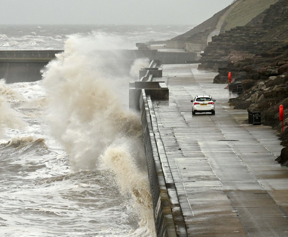 Huge waves crash onto the coastal road near Blackpool's North Shore