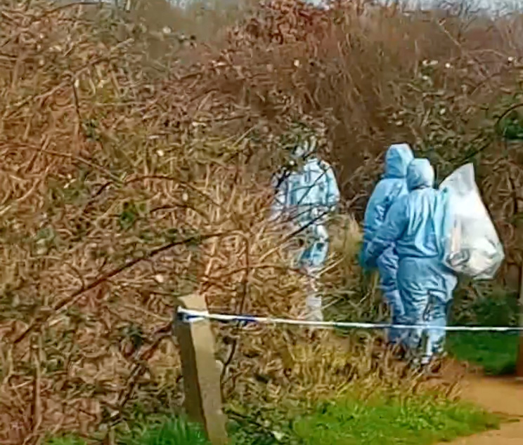 Forensic teams were seen carrying plastic evidence bags today