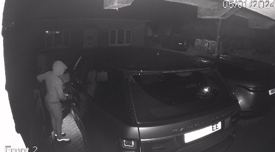 Hooded thieves breaking into the Range Rover while it sat on Andy's drive