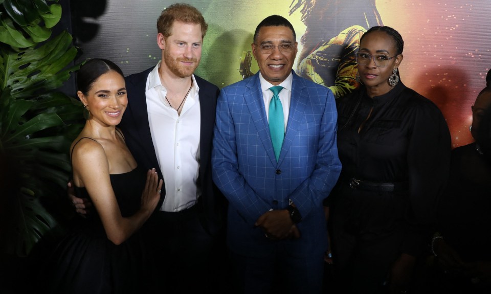 Harry and Meghan posing with Jamaican PM Andrew Holness