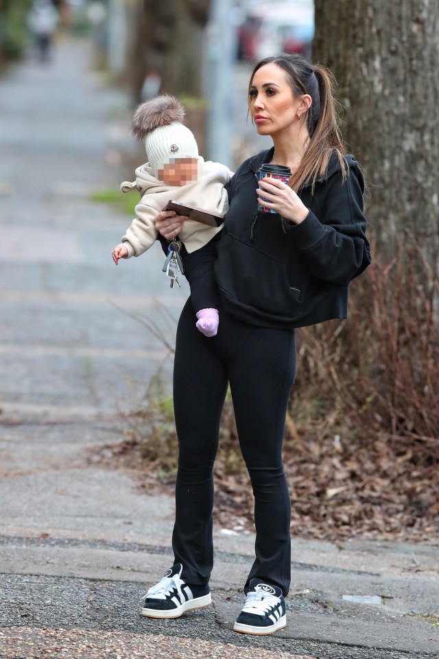 EXCLUSIVE: * WEB POST TIME Midday GMT 12th jan 2024 **..Lauryn Goodman Is Seen For The First Time Following Reports That Kyle Walker IS The Father Of Her Baby Daughter...The reality star was spotted carrying the five-month-old tot while on a coffee run in Sussex on Thursday (January 11, 2024)...Lauryn, who was dressed in all black, balanced her hot drink on a wall as she stopped to take a tense looking call on her mobile phone...Her baby girl was wrapped up in a cosy looking hoodie with ears, a woolly bobble hat and pink socks...Manchester City defender Walker, who has split from wife Annie Kilner, was rumoured to be the biological father of Lauryn’s daughter since she gave birth in August...Annie, who announced their separation on Sunday, reportedly dumped the footballer after confronting him over claims he was the father of both Lauryn’s children.....Pictured: Lauryn Goodman..Ref: SPL10669677 110124 EXCLUSIVE..Picture by: SplashNews.com....Splash News and Pictures..USA: 310-525-5808 .UK: 020 8126 1009..eamteam@shutterstock.com....World Rights..