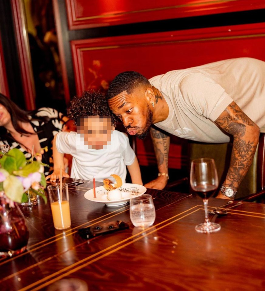 Toney helps his son blow out a candle on his birthday