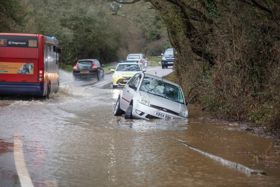 A car lies partially submerged on the A272 at Petersfield, Hampshire, as Storm Henk wreaked havoc