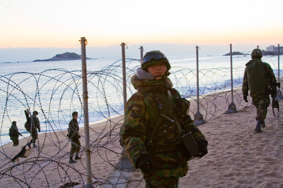 Sunbathers may be put off by barbed wire on the beaches intended to deter invasion by bitter enemy South Korea