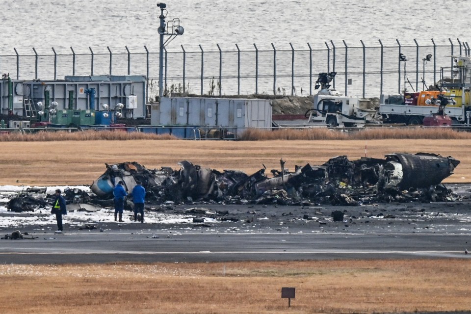 The wreckage of the Japan coastguard aircraft where five people were killed