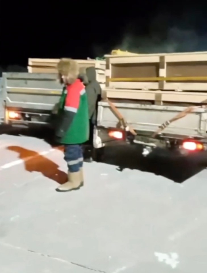 Wooden coffins are unloaded before corpses are returned to grieving families