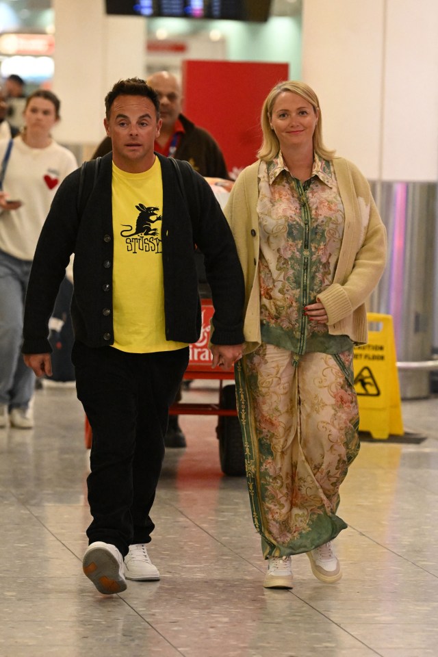 Ant McPartlin and Anne-Marie Corbett held hands as they arrived home in the UK after their holiday