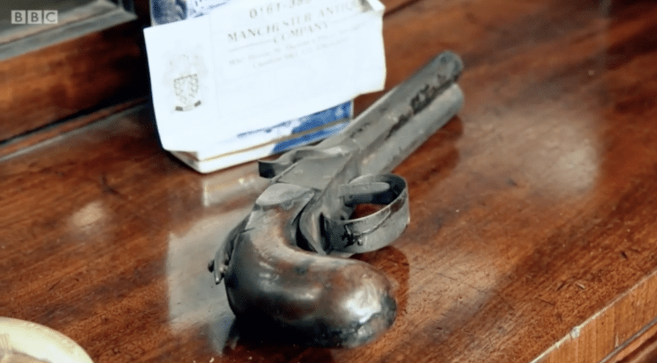 The dealer saw the pistol in an antiques show