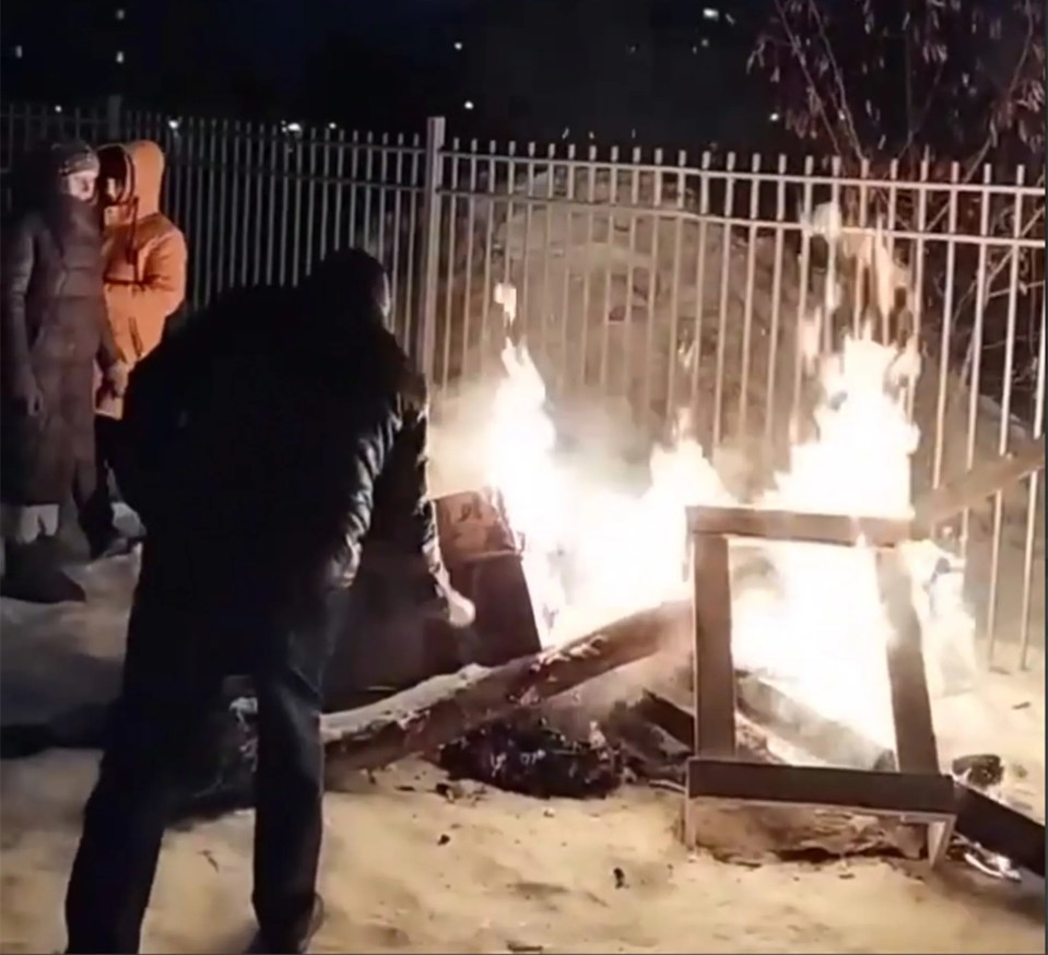 Civilians build fires outside as it is warmer than staying indoors