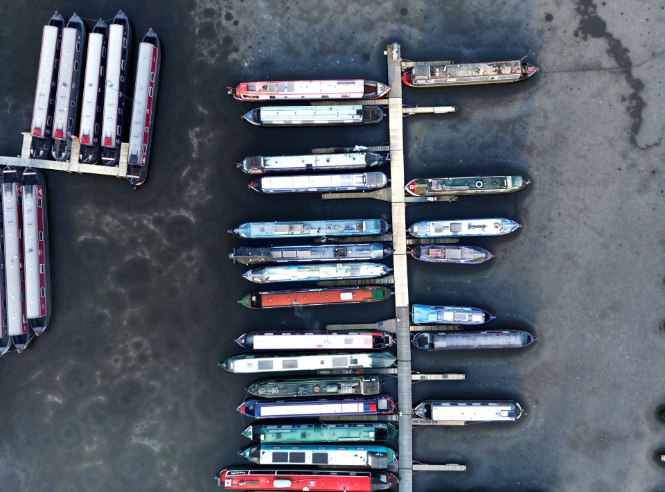 Canal barges and narrowboats are surrounded by ice in Festival Park marina, Stoke-on-Trent, Staffordshire