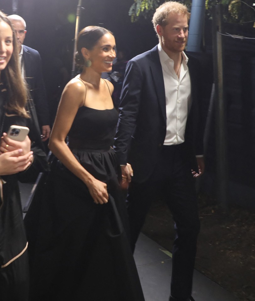 Harry and Meghan held hands on the red carpet in Kingston, Jamaica