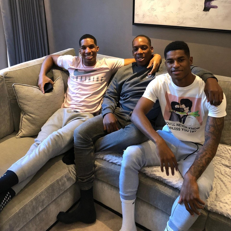 Marcus, right, with brothers Dane Rashford, left, and Dwaine Maynard, centre