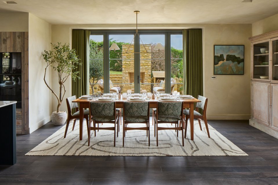 A lavish dining area offers high ceilings and opulent modern design