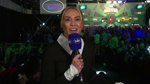 a woman is holding a microphone in front of a crowd of people .