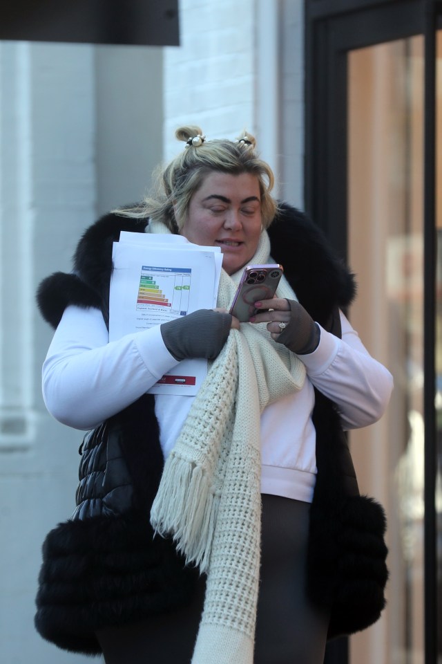 Gemma clutched onto some documents and her phone as she strolled down the street