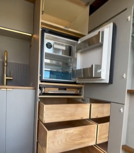 The kitchen area's fridge comes with a freezer and plenty of storage