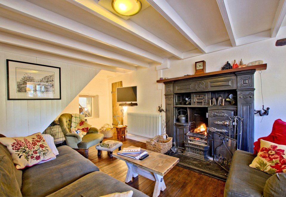 A snug living room with a roaring fire awaits the buyer