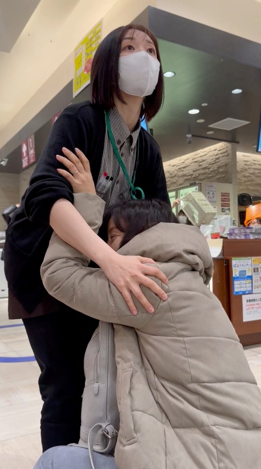 People cling onto one another inside a store in Ishikawa when the first of the quakes hit