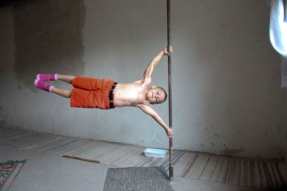 ROMANIA - UNDATED: EXCLUSIVE. Giuliano Stroe works out at home in Romania. Tensing their muscles and snarling into the camera, brothers Giuliano, six, and Claudiu, four, are training to be the world's strongest boys. The tiny muscle men have been performing frightening acrobatic feats and lifting weights since they were toddlers. Dad Iulian Stroe, 35, is determined to make them famous and puts them through a gruelling two-hour regime each morning. Allowing us exclusive access to his home in Romania for the first time, Iulian says he can make the boys even more 'pumped up' in three weeks in return for money. (Photo by Barcroft Media / Getty Images)