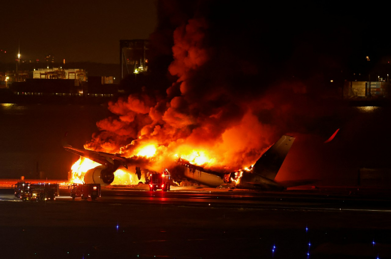 The plane's wreckage became a fiery inferno as all flights were suspended from the busy Tokyo airport