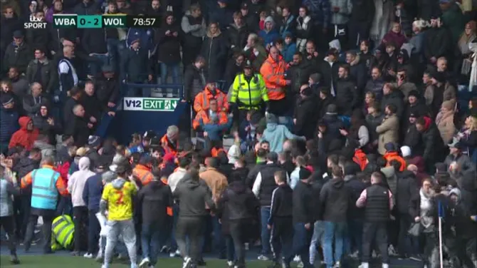 Violence spilled onto the pitch with the players taken into the dressing room