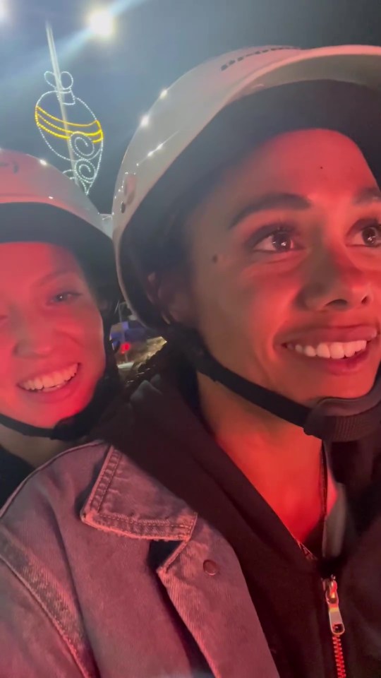 two people wearing helmets are smiling for the camera