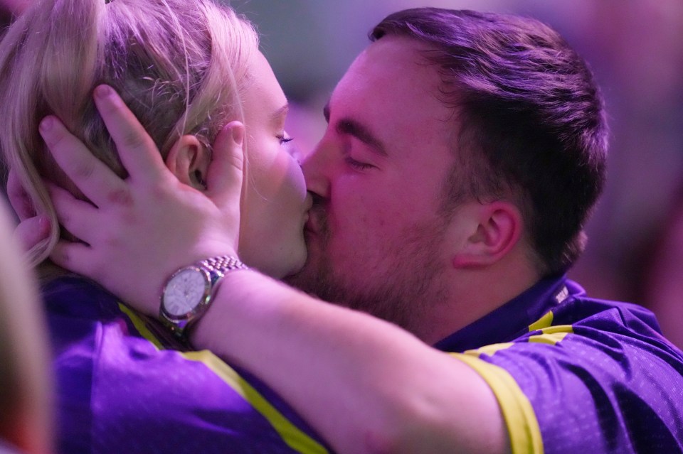 Littler and Eloise share a kiss after he defeated Brendan Dolan