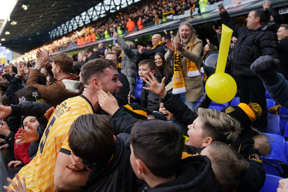 Maidstone star George Fowler celebrates with the fans at Portman Road