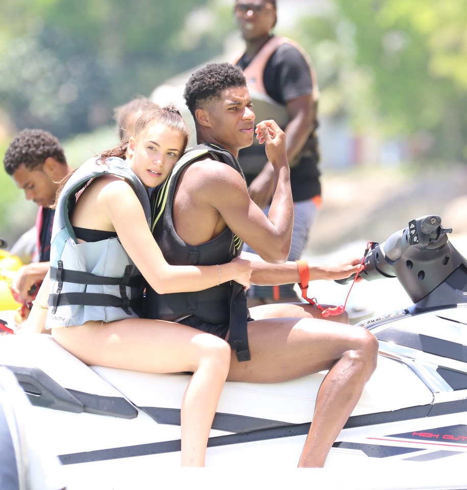 The couple pictured enjoying a jet ski ride in Barbados during the good times