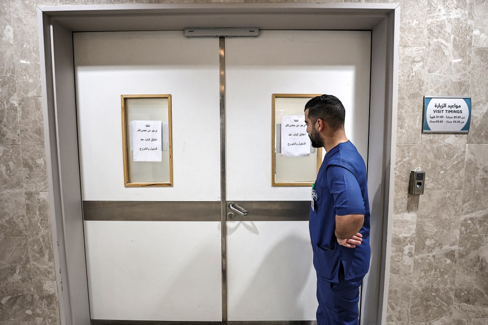 A medic stands outside the door of a ward at the Ibn Sina hospital in Jenin