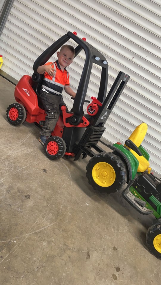 Keelan riding his modified toy tractor, which helped spark his passion for motors