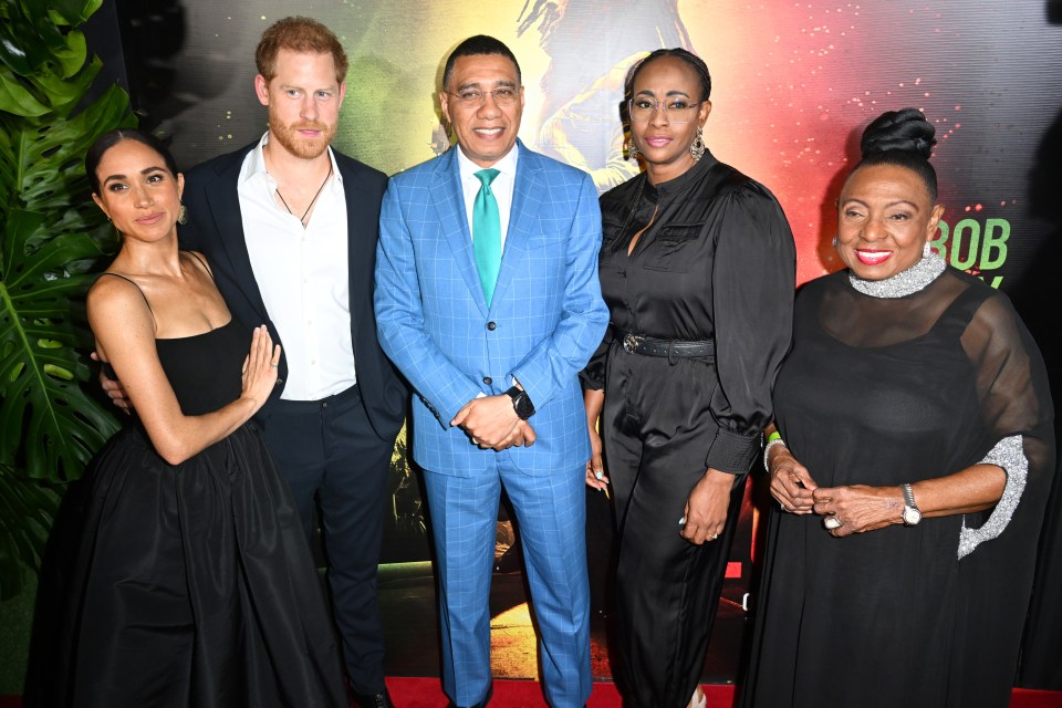 Harry and Meghan posing with Jamaican PM Andrew Holness