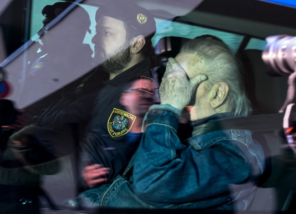 The monster tried to cover his face as he was escorted back to prison