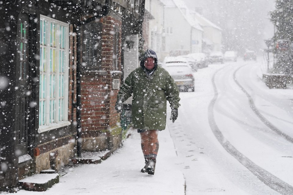 A man walking through snow in Lenham, Kent yesterday