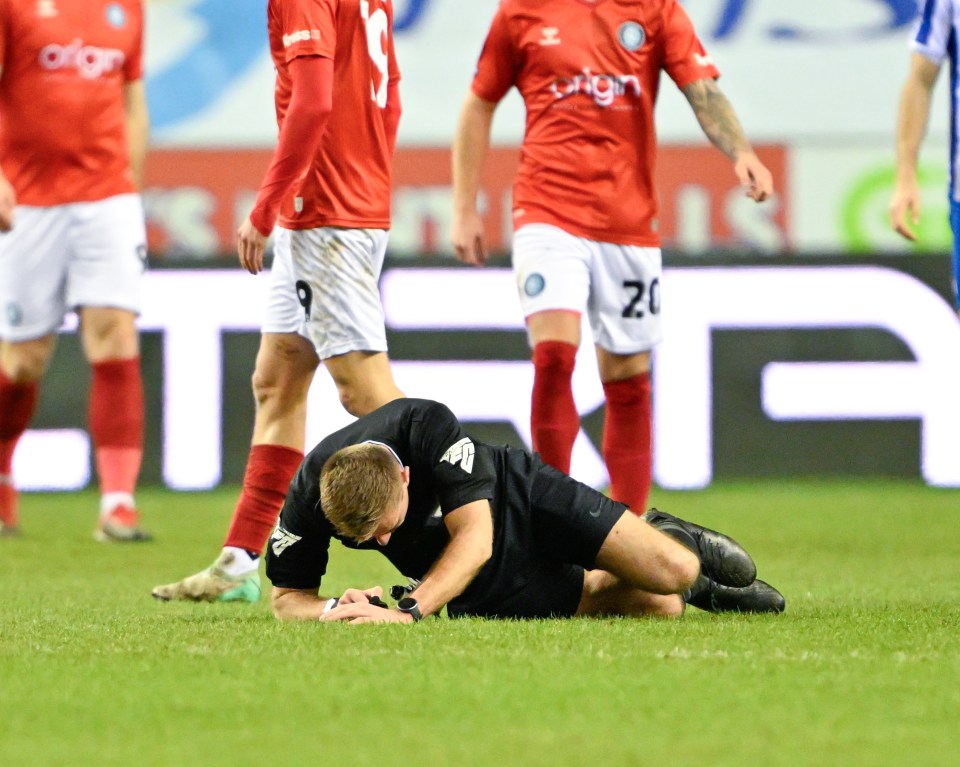 A fan was drafted in as a fourth official after a ref injured his head in a horror collision