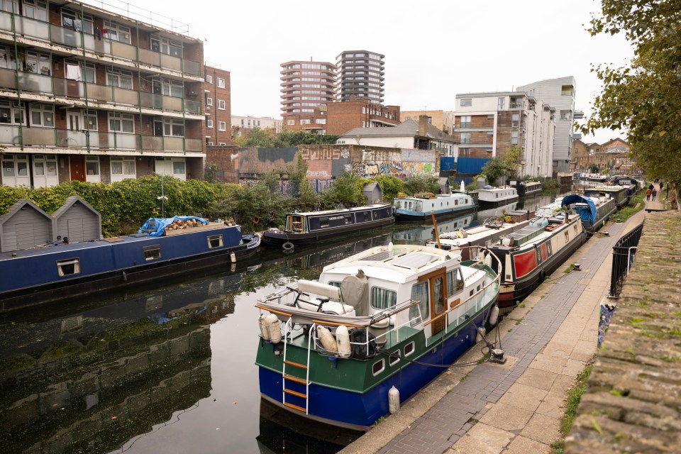 Dozens of boats are moored along the canal