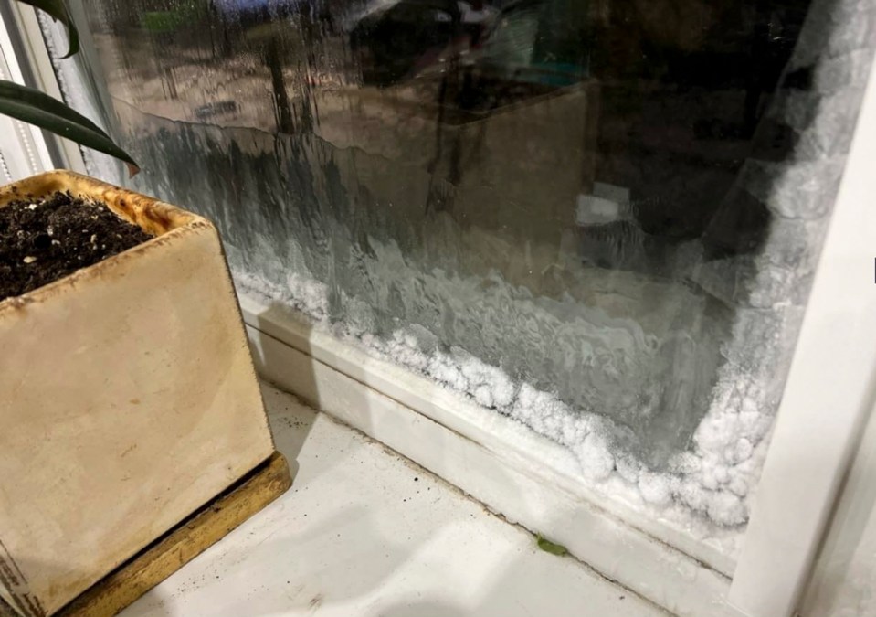 Ice gathers inside the window of a home without heating