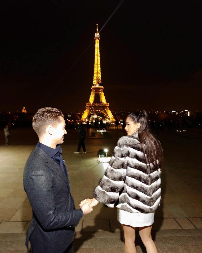 AJ Pritchard held his girlfirend's left hand in front of the Eiffel Tower